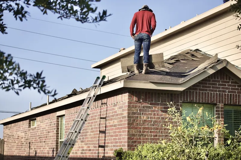 Professional roofer working on a residential roof in Woodview Estates